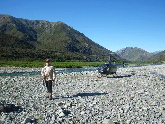 A helicopter on a river bed after flying in an angler in New Zealand